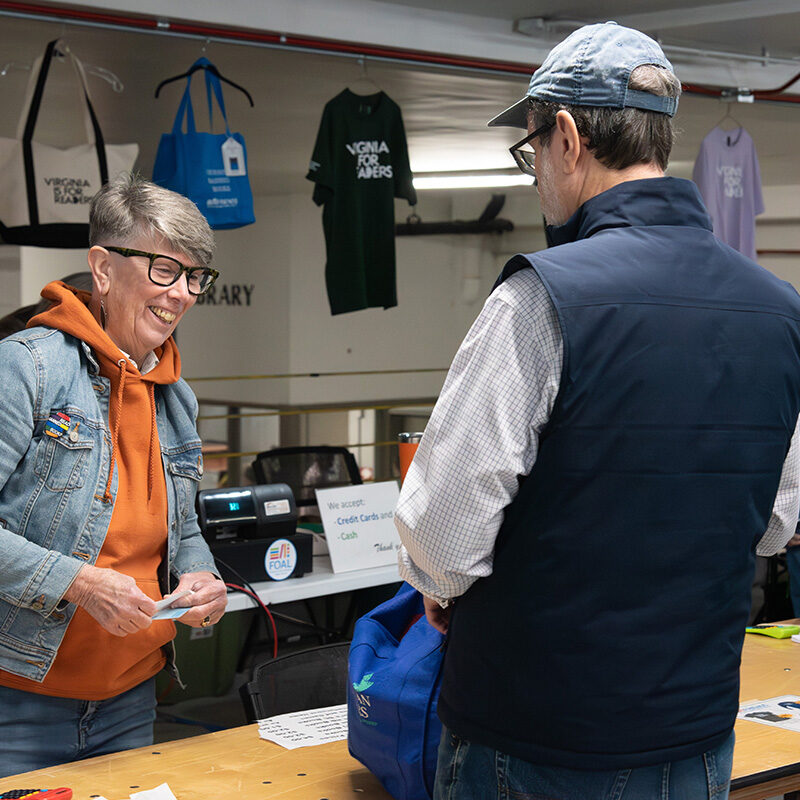 Library Director Diane Kresh talking to a FOAL book sale customer.